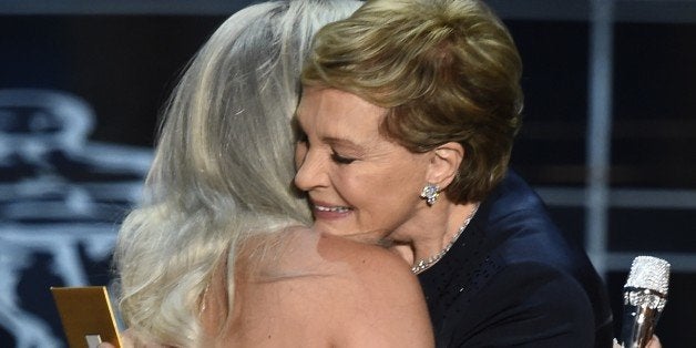 Julie Andrews (R) hugs Lady Gaga on stage at the 87th Oscars February 22, 2015 in Hollywood, California. AFP PHOTO / Robyn BECK (Photo credit should read ROBYN BECK/AFP/Getty Images)