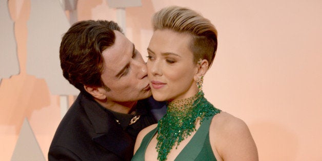 HOLLYWOOD, CA - FEBRUARY 22: Actor John Travolta (L) and actress Scarlett Johansson attend the 87th Annual Academy Awards at