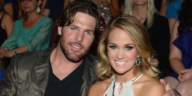 NASHVILLE, TN - JUNE 04: Mike Fisher (L) and Carrie Underwood attend the 2014 CMT Music awards at the Bridgestone Arena on J