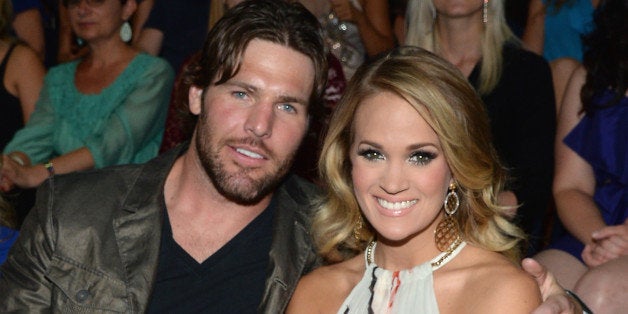 NASHVILLE, TN - JUNE 04: Mike Fisher (L) and Carrie Underwood attend the 2014 CMT Music awards at the Bridgestone Arena on June 4, 2014 in Nashville, Tennessee. (Photo by Larry Busacca/WireImage)