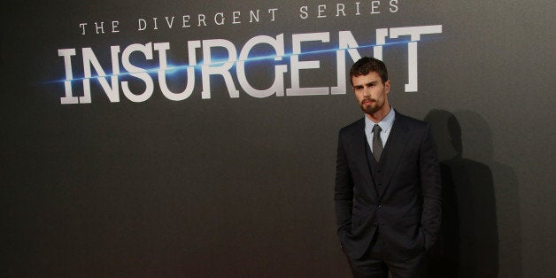 Actor Theo James poses for photographers upon arrival at a central London cinema for the World Premiere of Insurgent, Wednesd
