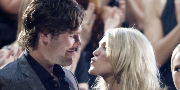 Carrie Underwood kisses her boyfriend Mike Fisher of the NHL Ottawa Senators as she won "Video of the Year" at the 2010 CMT Awards in Nashville, Tenn. Wednesday, June 9, 2010. (AP Photo/M. Spencer Green)