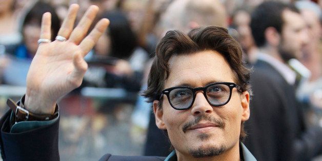 US actor Johnny Depp poses for the cameras as he arrives the the UK Premiere of the film 'Pirates of the Caribbean - On Stranger Tides ' in London, Thursday, May, 12, 2011. (AP Photo/Alastair Grant)