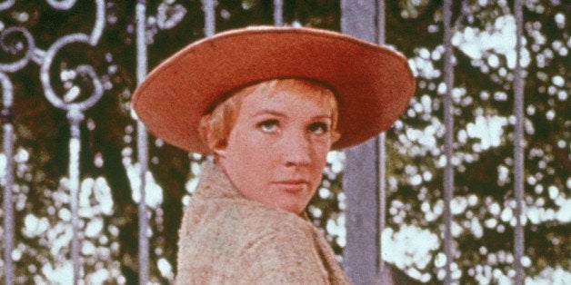 British actress Julie Andrews stands on her toes while she holds a guitar case in a scene from the film 'The Sound of Music,' directed by Robert Wise, 1965. (Photo by 20th Century Fox/Courtesy of Getty Images)