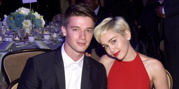 LOS ANGELES, CA - FEBRUARY 07: Recording artist Miley Cyrus (R) and Patrick Schwarzenegger attend the Pre-GRAMMY Gala and Salute to Industry Icons honoring Martin Bandier at The Beverly Hilton Hotel on February 7, 2015 in Los Angeles, California. (Photo by Larry Busacca/Getty Images)