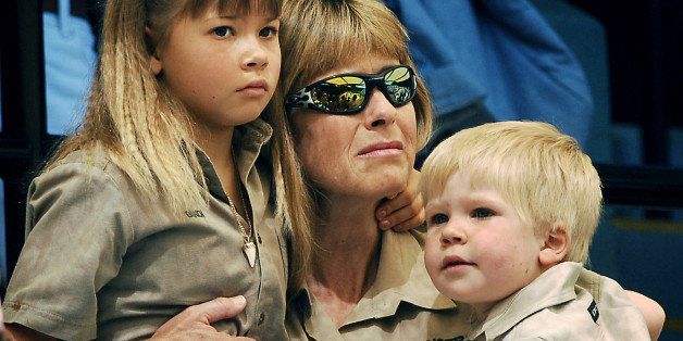 Terri Irwin, center, wife of Australian environmentalist and television personality Steve Irwin with daughter Bindi, left, and son Bob attend the memorial service for her husband at Australia Zoo in Beerwah, Australia, Wednesday, Sept. 20, 2006. Irwin, known as the "Crocodile Hunter" was killed Sept. 4 by a stingray barb during a diving expedition on the Great Barrier Reef. (AP Photo/Dave Hunt, POOL) 