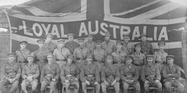 Group portrait of officers of the 3rd Battalion in front of a large Union Jack flag bearing the words 'Loyal Australia' acros