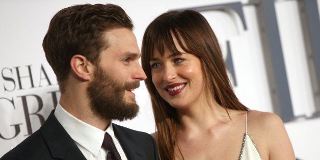 Jamie Dornan and Dakota Johnson pose for photographers upon arrival at the UK premiere of the film 'Fifty Shades of Grey' in