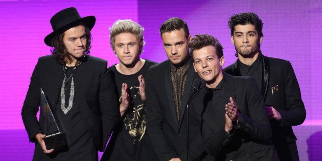 Harry Styles, from left, Niall Horan, Liam Payne, Louis Tomlinson and Zayn Malik of the musical group One Direction accept the award for pop/rock band, duo or group on stage at the 42nd annual American Music Awards at Nokia Theatre L.A. Live on Sunday, Nov. 23, 2014, in Los Angeles. (Photo by Matt Sayles/Invision/AP)