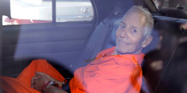 Robert Durst is transported from Orleans Parish Criminal District Court to the Orleans Parish Prison after his arraignment in New Orleans, Tuesday, March 17, 2015. Durst was rebooked on charges of being a convicted felon in possession of a firearm, and possession of a weapon with a controlled dangerous substance, a small amount of marijuana. (AP Photo/Gerald Herbert)