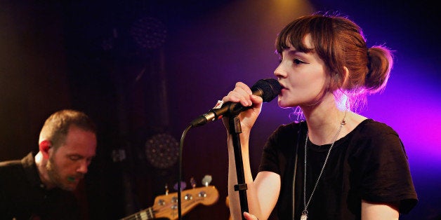 NEW YORK, NY - DECEMBER 10: Iain Cook and Lauren Mayberry of CHVRCHES perform at the private CHVRCHES Concert at The McKittrick Hotel; Concert To Air On SiriusXM's SiriusXMU Channel on December 10, 2013 in New York City. (Photo by Cindy Ord/Getty Images for SiriusXM)