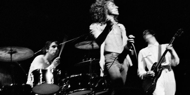 Singer Roger Daltrey of the Who twirls his hand microphone by its cord during the final performance of the rock opera "Tommy," at the Metropolitan Opera House in New York, June 7, 1970. Drummer Keith Moon and lead guitarist Pete Townshend, who wrote "Tommy" perform in the background. (AP Photo/Harry Harris)