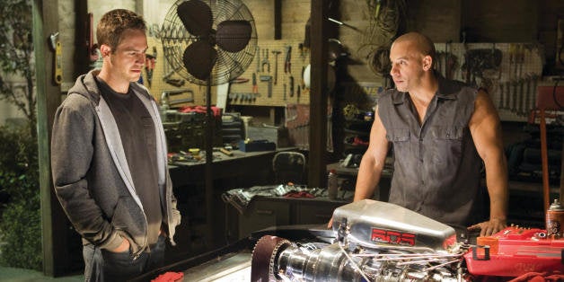 In this film publicity still released by Universal Pictures, Paul Walker, left, and Vin Diesel, are shown in a scene from "Fast & Furious." Universal Pictures has delayed the release of âFast & Furious 7â for almost a year following the death of Paul Walker. The studio announced early Monday, Dec. 23, 2013, that the âFast & Furiousâ sequel will be released in April 2015, instead of July next year. Shooting on the film was about midway through when the 40-year-old Walker died in a car crash outside of Los Angeles. (AP Photo/Universal Pictures, Jaimie Trueblood)