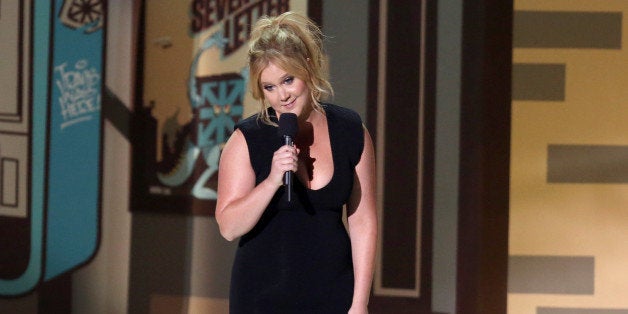 Host Amy Schumer speaks at the MTV Movie Awards at the Nokia Theatre on Sunday, April 12, 2015, in Los Angeles. (Photo by Mat