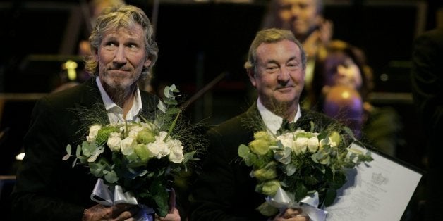 Roger Waters, left, and Nick Mason, right, of the British group Pink Floyd, receive the Polar Music Prize from His Majesty King Carl XVI Gustaf of Sweden, unseen, at a gala ceremony at the Stockholm Concert Hall on Tuesday, Aug. 26, 2008. The Polar Music Prize is Sweden's biggest music award and is often called the Nobel Prize of music. It comes with a 1 million kronor (US$157,700) prize for each winner and is typically split between pop artists and classical musicians. (AP Photo / Mats Andersson / SCANPIX) ** SWEDEN OUT **