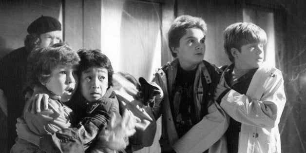 From left to right, Anne Ramsey, Jeff Cohen, Jonathan Ke Quan, Corey Feldman and Sean Astin with frightened expressions in a