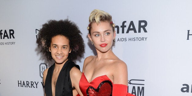 Honoree Miley Cyrus, right, arrives with friend Tyler Ford at the 6th Annual amfAR New York Inspiration Gala at Spring Studios on Tuesday, June 16, 2015, in New York. (Photo by Evan Agostini/Invision/AP)