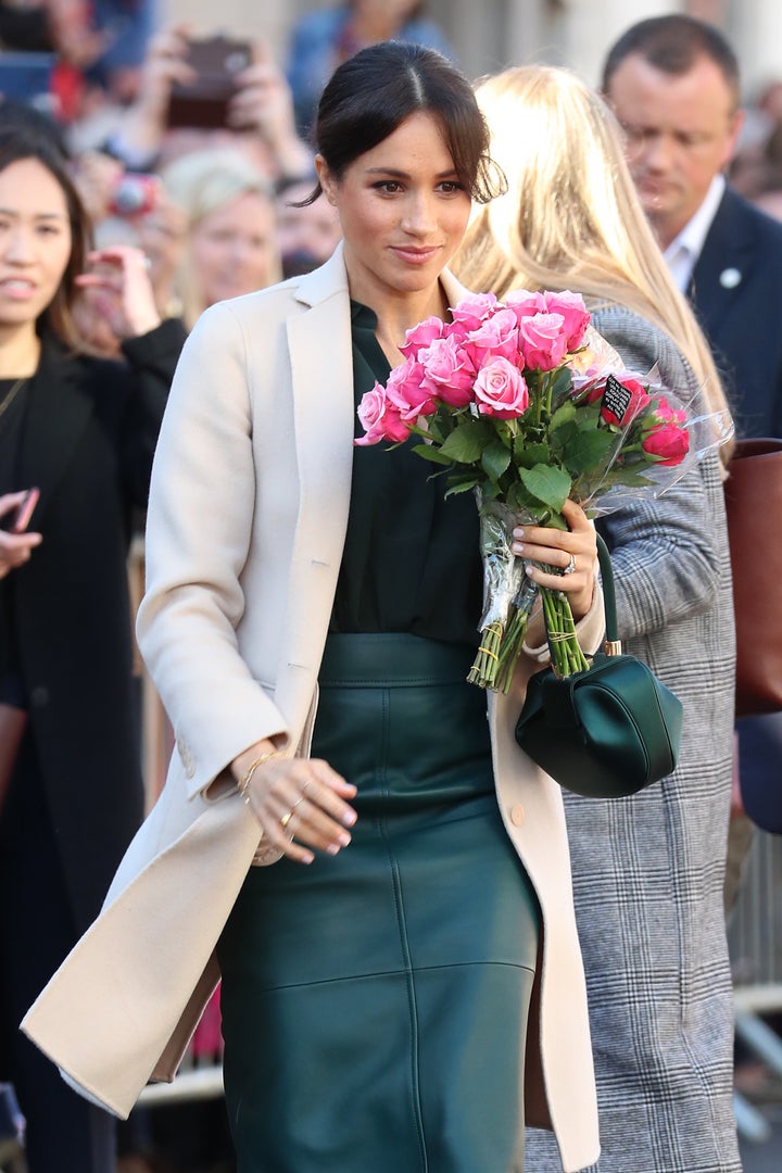 Holding flowers from a royal fan. 