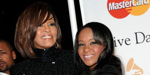 FILE - In this Feb. 12, 2011 file photo, singer Whitney Houston, left, and her daughter Bobbi Kristina arrive at the Pre-Grammy Gala & Salute to Industry Icons with Clive Davis honoring David Geffen in Beverly Hills, Calif. Bobbi Kristina Brown has been spotted wearing a sparkly bauble on her ring finger, but she's not planning on getting married anytime soon. A rep for Brown's mother, the late Whitney Houston, says the 19-year-old is âsimply wearing her mother's ringâ and that she's not engaged. (AP Photo/Dan Steinberg, file)