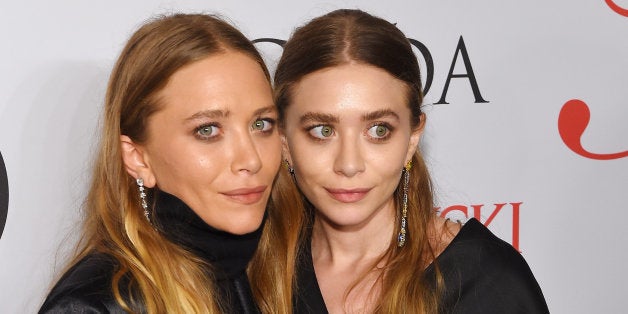 NEW YORK, NY - JUNE 01: Mary-Kate Olsen and Ashley Olsen pose on the winners walk at the 2015 CFDA Fashion Awards at Alice T