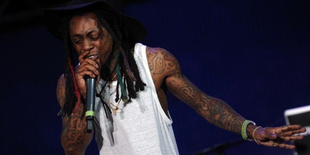 Singer Lil Wayne performs during a free concert in Champ de Mars, downtown Port-au-Prince on June 26, 2015. AFP PHOTO/HECTOR