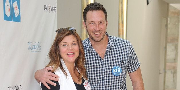 LOS ANGELES, CA - APRIL 19: Actress Tiffani Thiessen and husband Brady Smith arrive at the Milk + Bookies 6th Annual Story Time Celebration at Skirball Cultural Center on April 19, 2015 in Los Angeles, California. (Photo by Gregg DeGuire/WireImage)