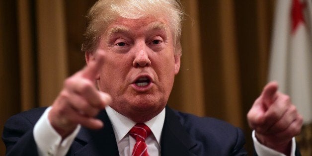 Donald Trump gestures while speaking surrounded by people whose families were victims of illegal immigrants on July 10, 2015 while meeting with the press at the Beverly Wilshire Hotel in Beverly Hills, California, where some shared their stories of the loss of a loved one. The US business magnate Trump, who is running for pesident in the 2016 presidential elections, angered members of the Latino community with recent comments but says he will win the Latino vote. AFP PHOTO / FREDERIC J. BROWN (Photo credit should read FREDERIC J. BROWN/AFP/Getty Images)