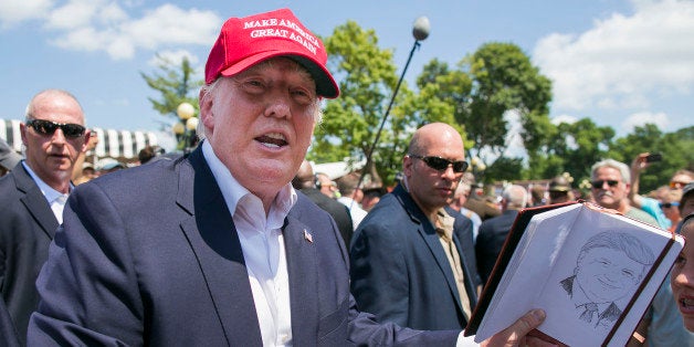 UNITED STATES - August 15: Republican presidential candidate Donald Trump laughs as he is asked to sign a sketch drawing of h