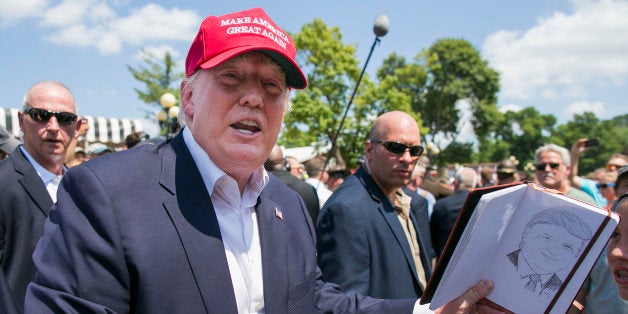 UNITED STATES - August 15: Republican presidential candidate Donald Trump laughs as he is asked to sign a sketch drawing of himself at the Iowa State Fair in Des Moines, Iowa, on Saturday, August 15, 2015. (Photo By Al Drago/CQ Roll Call)