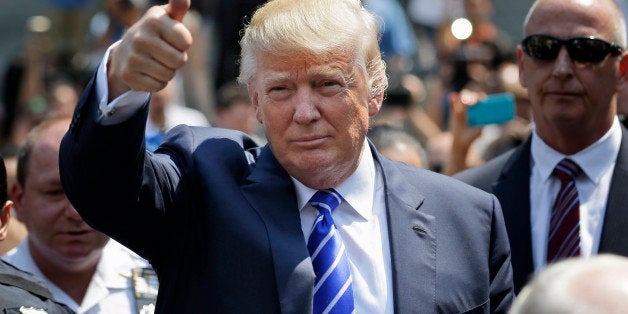 Donald Trump gives a thumbs-up as he leaves for lunch after being summoned for jury duty in New York, Monday, Aug. 17, 2015.