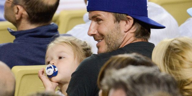 LOS ANGELES, CA - AUGUST 27: David Beckham (R) and daughter Harper Beckham attend a baseball game between the Chicago Cubs and the Los Angeles Dodgers at Dodger Stadium on August 27, 2013 in Los Angeles, California. (Photo by Noel Vasquez/Getty Images)