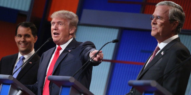 CLEVELAND, OH - AUGUST 06: Republican presidential candidates (L-R) Wisconsin Gov. Scott Walker, Donald Trump and Jeb Bush participate in the first prime-time presidential debate hosted by FOX News and Facebook at the Quicken Loans Arena August 6, 2015 in Cleveland, Ohio. The top-ten GOP candidates were selected to participate in the debate based on their rank in an average of the five most recent national political polls. (Photo by Chip Somodevilla/Getty Images)