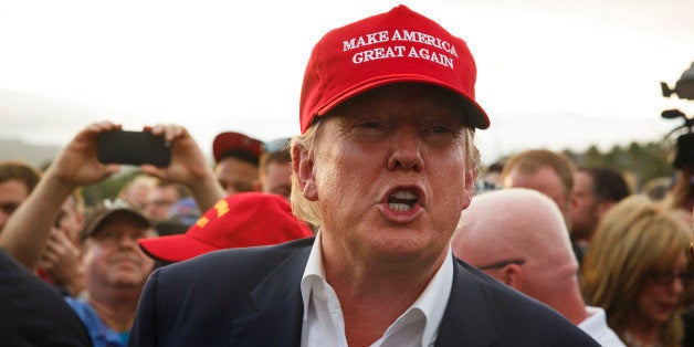 Donald Trump, president and chief executive officer of Trump Organization Inc. and 2016 Republican presidential candidate, is escorted by security after a rally aboard the Battleship USS Iowa in San Pedro, California, U.S., on Tuesday, Sept. 15, 2015. Trump said Sunday that he would flesh out his tax proposals in the coming weeks, but again vowed to raise rates on hedge fund managers, who the billionaire has portrayed as 'getting away with murder.' Photographer: Patrick T. Fallon/Bloomberg via Getty Images 