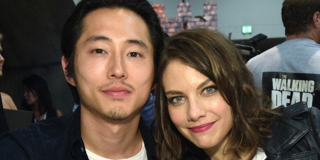 Steven Yeun, left, and Lauren Cohan attend AMC's "The Walking Dead" autograph signing on Day 2 of Comic-Con International on