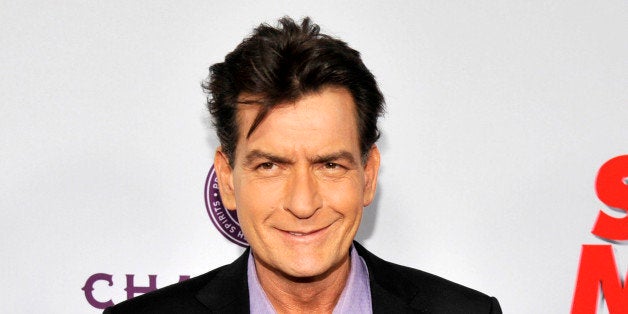 FILE - In this April 11, 2013 file photo, Charlie Sheen, a cast member in "Scary Movie V," poses at the Los Angeles premiere