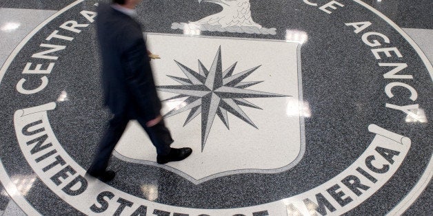 A man crosses the Central Intelligence Agency (CIA) logo in the lobby of CIA Headquarters in Langley, Virginia, on August 14, 2008. AFP PHOTO/SAUL LOEB (Photo credit should read SAUL LOEB/AFP/Getty Images)