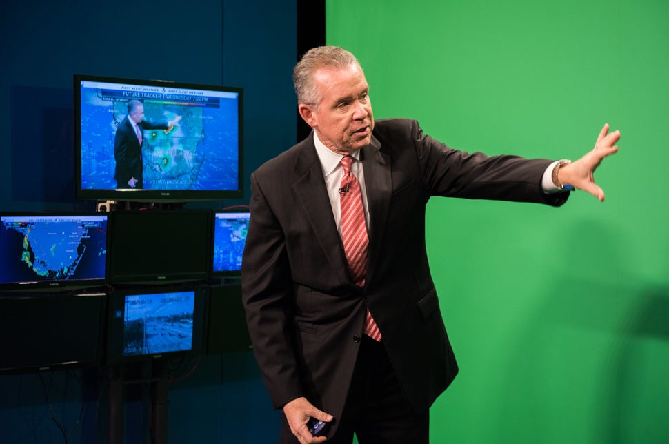 Morales in front of the green screen at NBC-6 during one of his weather
