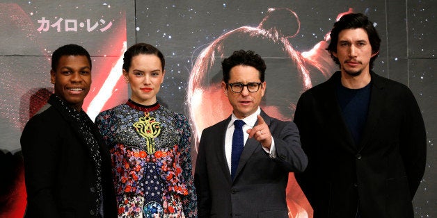 Director J.J. Abrams, second from right, and actors John Boyega, left, Daisy Ridley, second left, and Adam Driver pose for the photographers during a press conference for their latest film "Star Wars: The Force Awakens" at a hotel in Urayasu, near Tokyo Friday, Dec. 11, 2015. (AP Photo/Shuji Kajiyama)