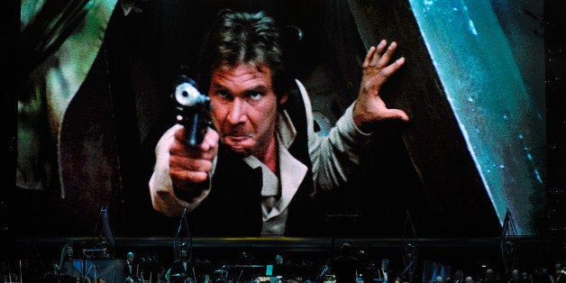 LAS VEGAS - MAY 29: Actor Harrison Ford's Han Solo character from 'Star Wars Episode VI: Return of the Jedi' is shown on screen while musicians perform during 'Star Wars: In Concert' at the Orleans Arena May 29, 2010 in Las Vegas, Nevada. The traveling production features a full symphony orchestra and choir playing music from all six of John Williams' Star Wars scores synchronized with footage from the films displayed on a three-story-tall, HD LED screen. (Photo by Ethan Miller/Getty Images)