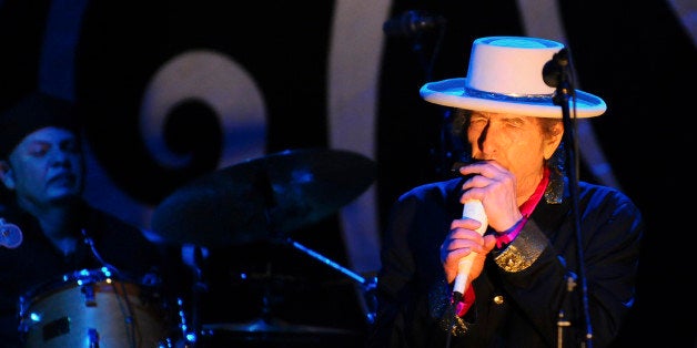 Singer Bob Dylan (R) performs during his show in Vietnam's southern Ho Chi Minh city April 10, 2011. Dylan is in Vietnam for a one day performance. REUTERS/Stringer (VIETNAM - Tags: ENTERTAINMENT)