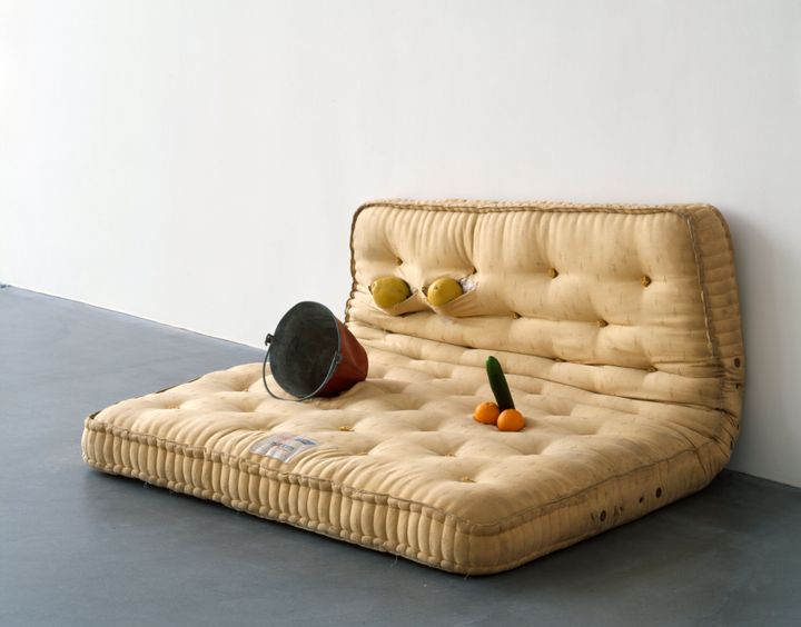 Lucas' 1994 installation "Au Naturel," featuring a mattress, melons, oranges, a cucumber and a water bucket.