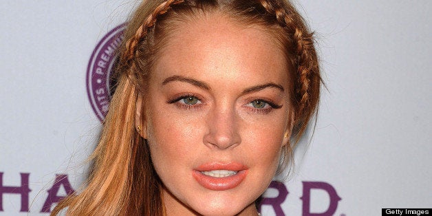 HOLLYWOOD, CA - APRIL 11: Actress Lindsay Lohan arrives at the 'Scary Movie V' Los Angeles premiere atArcLight Cinemas Cinera