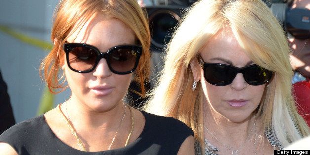 US actress Lindsey Lohan and her mother Dina (R) leave Airport Courthouse after the pre-trial hearing on January 30, 2013 in Los Angeles ,California. Lohan was ordered to appear before Los Angeles Superior Judge Stephanie Sautner on Wednesday for allegedly violating probation in a jewelry shoplifting case and to answer to a new charge of lying to Santa Monica police when she told them that she was not driving a Porsche involved in a collision with a truck on Pacific Coast Highway. Lohan avoided jail for now however, Judge Sautner scheduled the case to be brought back to court March 1st, and again on March 18th if the case goes to trial. AFP PHOTO/Joe Klamar (Photo credit should read JOE KLAMAR/AFP/Getty Images)