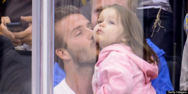 LOS ANGELES, CA - MAY 28: Harper Beckham (R) and David Beckham attend an NHL playoff game between the San Jose Sharks and the Los Angeles Kings at Staples Center on May 28, 2013 in Los Angeles, California. (Photo by Noel Vasquez/Getty Images)