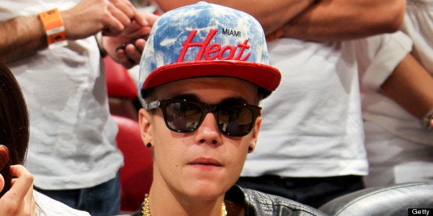 MIAMI, FL - JUNE 3: Recording artist Justin Bieber, right, looks on as the Indiana Pacers play the Miami Heat in Game Seven of the Eastern Conference Finals during the 2013 NBA Playoffs on June 3, 2013 at American Airlines Arena in Miami, Florida. NOTE TO USER: User expressly acknowledges and agrees that, by downloading and/or using this photograph, user is consenting to the terms and conditions of the Getty Images License Agreement. Mandatory copyright notice: Copyright NBAE 2013 (Photo by Issac Baldizon/NBAE via Getty Images)