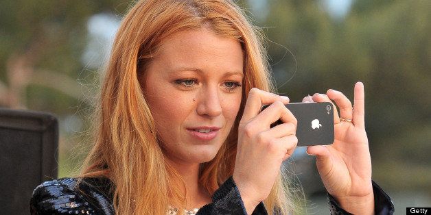 CAP D'ANTIBES, FRANCE - MAY 09: Blake Lively takes a photograph as the sun goes down during the Chanel Collection Croisiere Show 2011-12 at the Hotel du Cap on May 9, 2011 in Cap d'Antibes, France. (Photo by Dominique Charriau/WireImage)