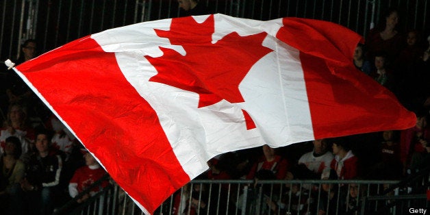 VANCOUVER, BC - MARCH 19: A Canadian flag is waves in the air in support of Team Canada during the Ice Sledge Hockey Bronze