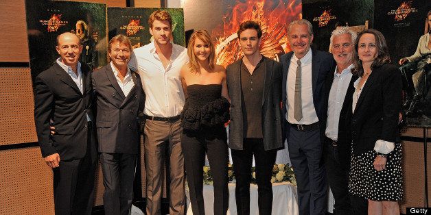 CANNES, FRANCE - MAY 18: (EMBARGOED FOR PUBLICATION IN UK TABLOID NEWSPAPERS UNTIL 48 HOURS AFTER CREATE DATE AND TIME. MANDATORY CREDIT PHOTO BY DAVE M. BENETT/GETTY IMAGES REQUIRED) (L to R) Producer Jon Kilik, Lionsgate Motion Picture Group Co-Chairman Patrick Wachsberger, actors Liam Hemsworth, Jennifer Lawrence, Sam Claflin, director Francis Lawrence, Lionsgate Motion Picture Group Co-Chairman Rob Friedman and producer Nina Jacobson attend The Hunger Games: Catching Fire photocall at the 2013 Cannes Film Festival at Majestic Barierre on May 18, 2013 in Cannes, France. (Photo by Dave M. Benett/Getty Images for Lionsgate)