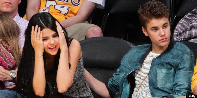 LOS ANGELES, CA - APRIL 17: Selena Gomez (L) and Justin Bieber attend a basketball game between the San Antonio Spurs and the Los Angeles Lakers at Staples Center on April 17, 2012 in Los Angeles, California. (Photo by Noel Vasquez/Getty Images)