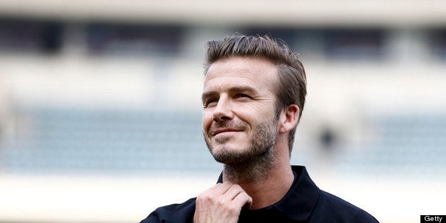 NANJING, CHINA - JUNE 18: (CHINA OUT) David Beckham plays football with young fans at at Nanjing Olympic Sports Center on Ju